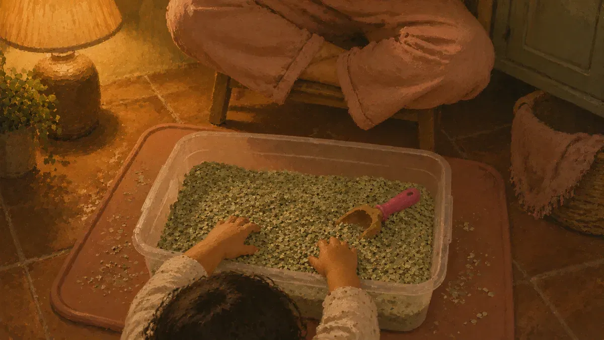 Sensory bin set up on a wipeable mat with supervising parent nearby for safe taste safe play